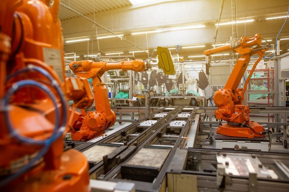 Machine automation replacing human labor in factory | CaseGuard Machines working in an aI automated factory, replacing human labor.
