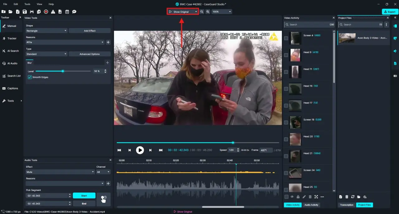 Video editing software interface showing two people in masks looking at phones in a parking lot, with timeline and editing panels visible.
