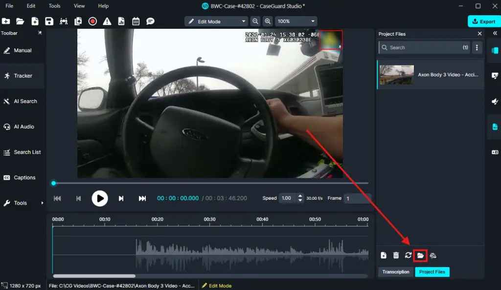 Screenshot of a video editor workspace showing a car interior (steering wheel and dashboard) video, playback controls, and a timeline; a red arrow points to a folder icon in the project panel on the right.