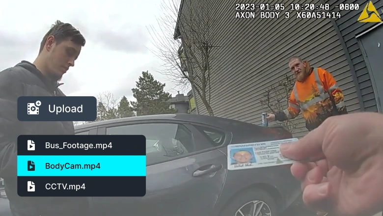 Bodycam view: a man in a gray hoodie and a worker in orange safety gear stand near a gray car, with an ID card shown in the foreground.