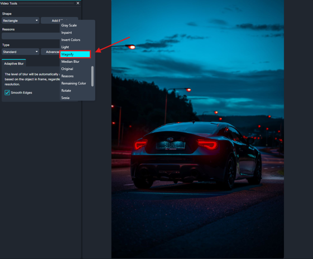 Magnify-cg | CaseGuard Dark blue sports car on a city street at blue hour, with red taillights; an editing panel with a Magnify tool is visible nearby.