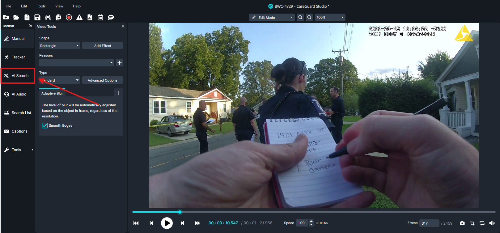ai-search | CaseGuard Video frame showing police officers on a suburban street; a person in the foreground writes notes in a small notebook held up close to the camera.